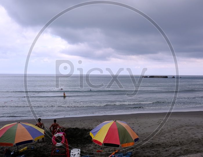 Tourists with beach beds and umbrellas at Qixingtan Beach