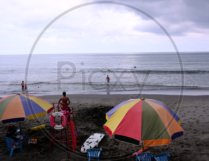 Tourists with beach umbrellas by the Qixingtan Beach