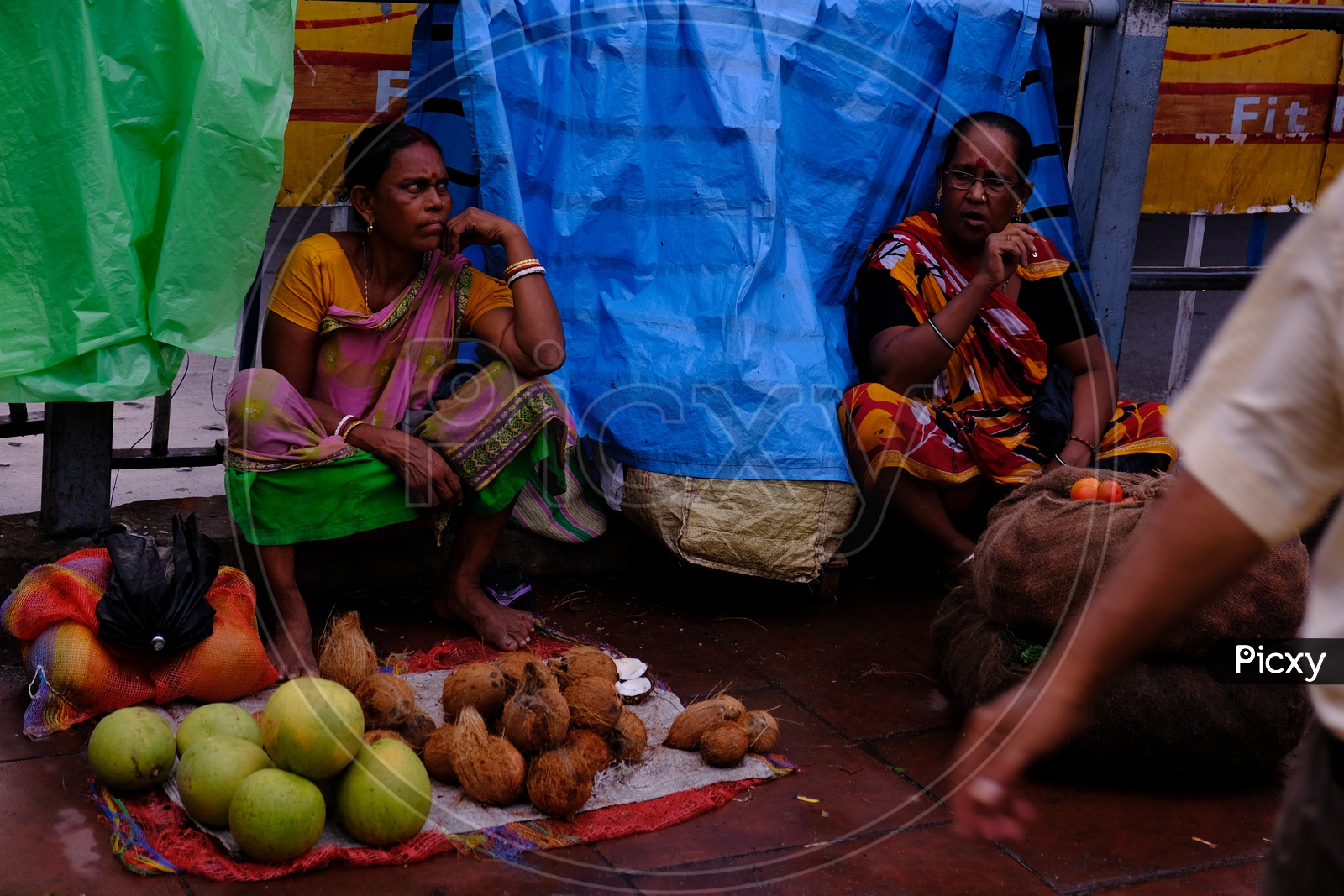Indian Street Vendor Woman selling Coconuts