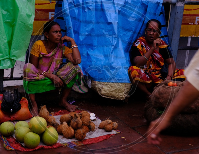 Indian Street Vendor Woman selling Coconuts