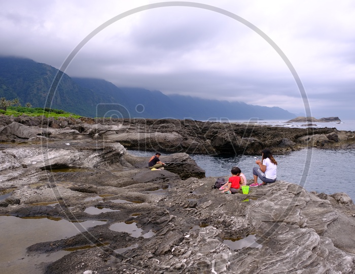 A Taiwanese Family at Dulan Beach with Mountains in Background