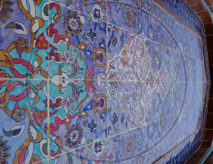 Intricate artistic mosaic design on walls at Katara Masjid