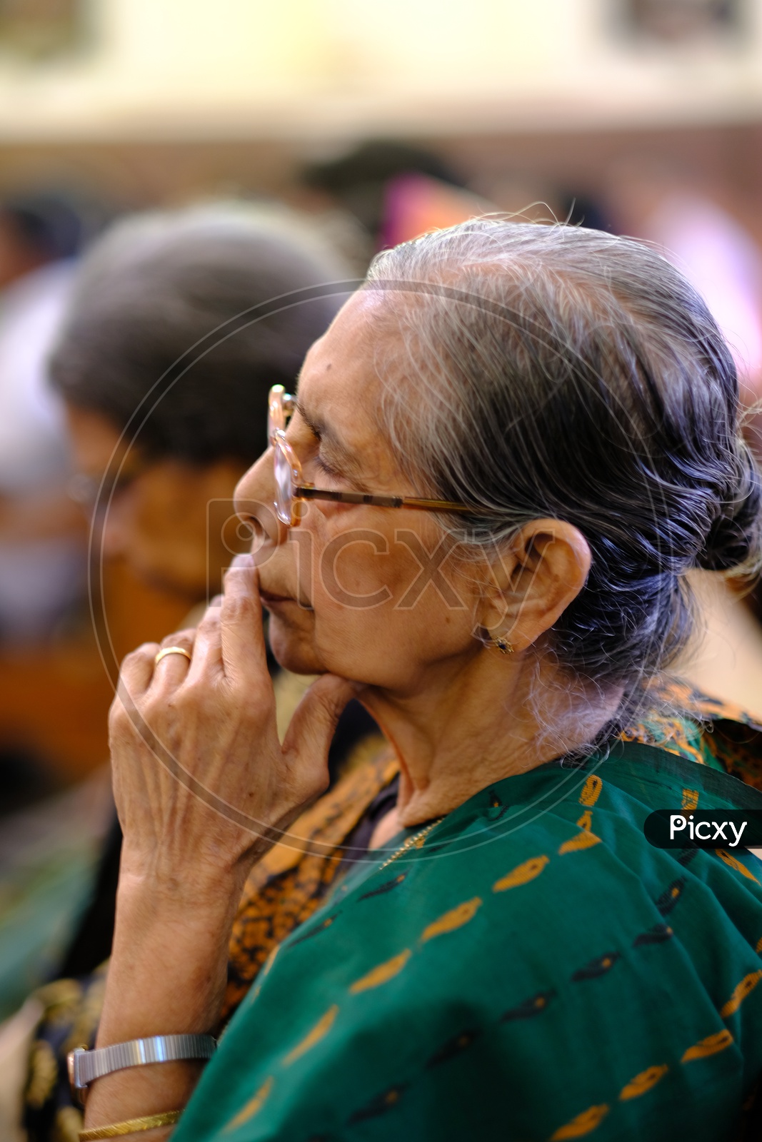 old  Woman Christian devotee Offering Prayers In a Church