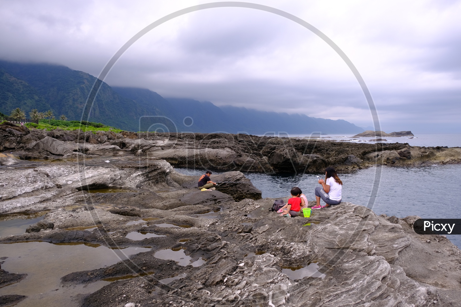 A Taiwanese Family at Dulan Beach with Mountains in Background