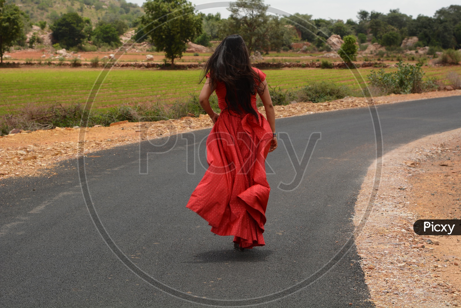 Image of A Young Girl Woman Running On Rural Village Roads-GR947539-Picxy