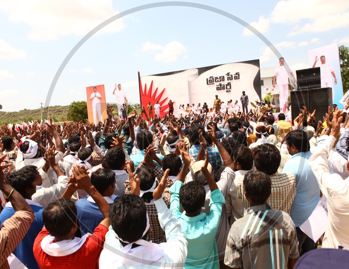 Crowd Of People Clapping Hands In a Public Political Meeting