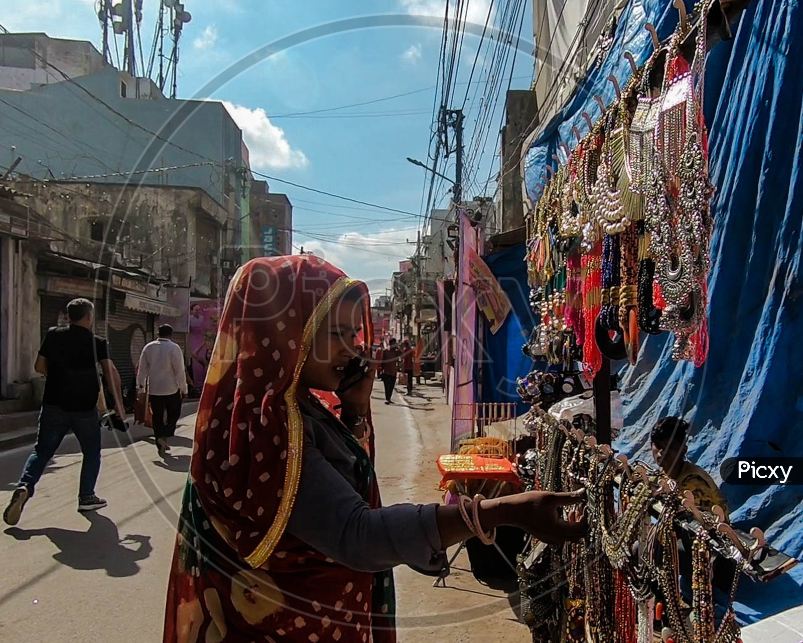 Lady purchasing jewelry from market