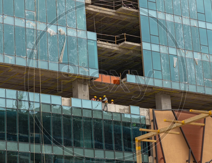 construction workers Installing Glass Facade to a new building