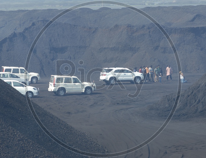 Car Chase In Coal Mines Between Black Sand Dunes For a Movie Shooting