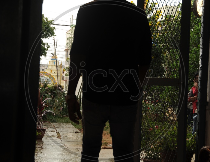 A man Walking Away From House From Door