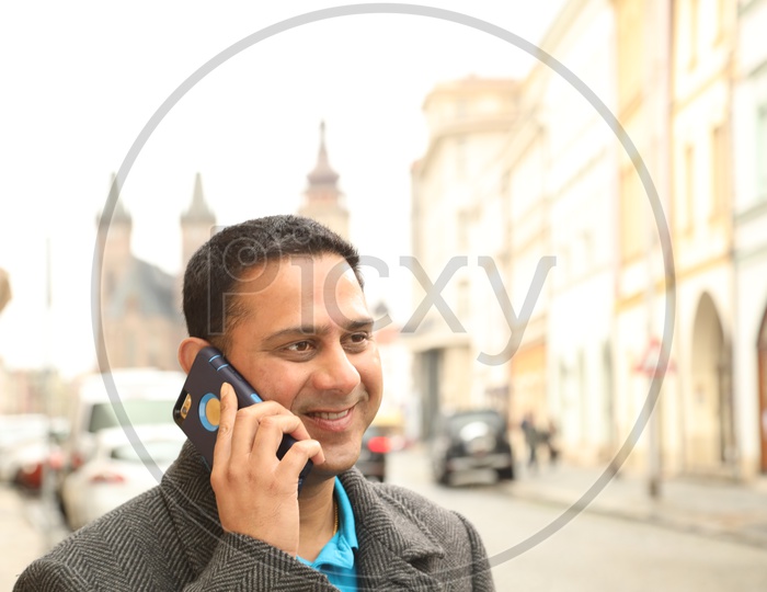 Indian man Speaking In Mobile Phone With Smile Face