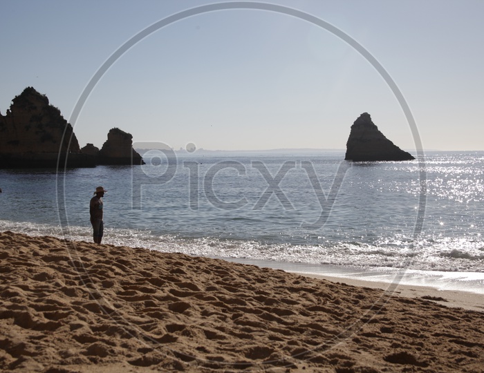 Man Standing In a Beach