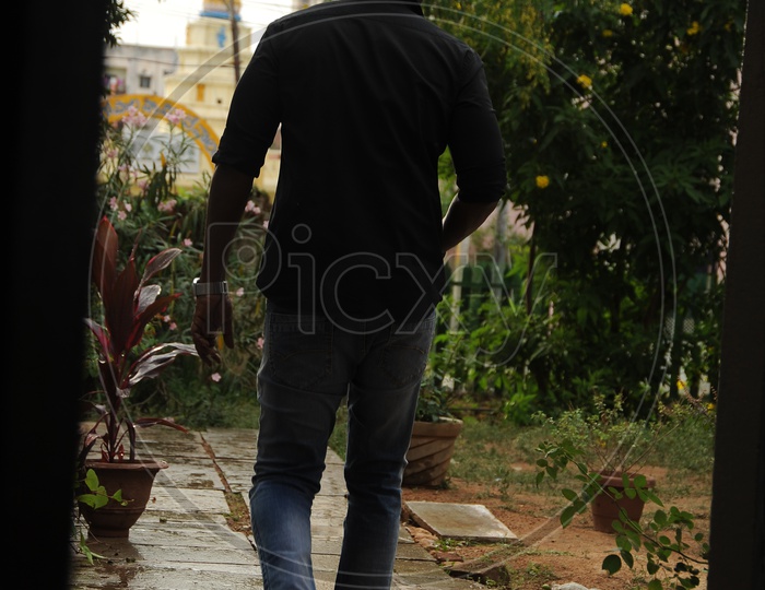 A man Walking Away From House From Door