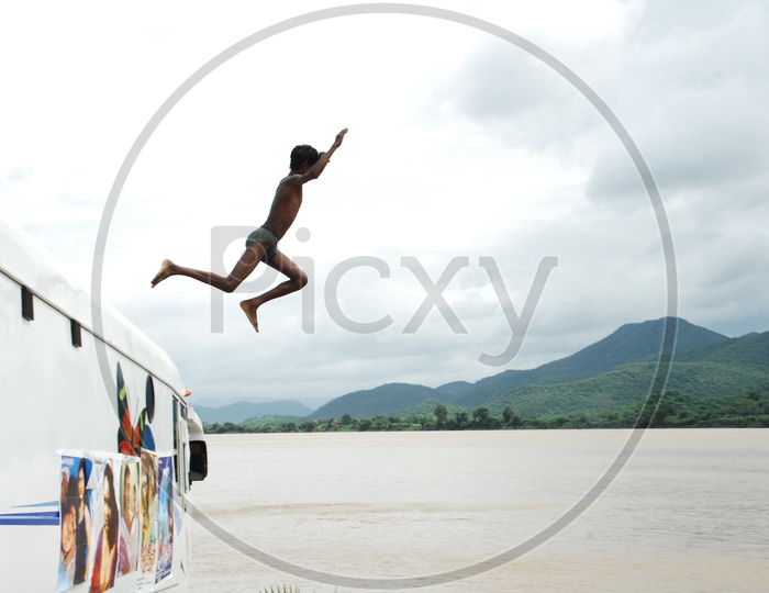 Boy Jumping Into River For Swimming
