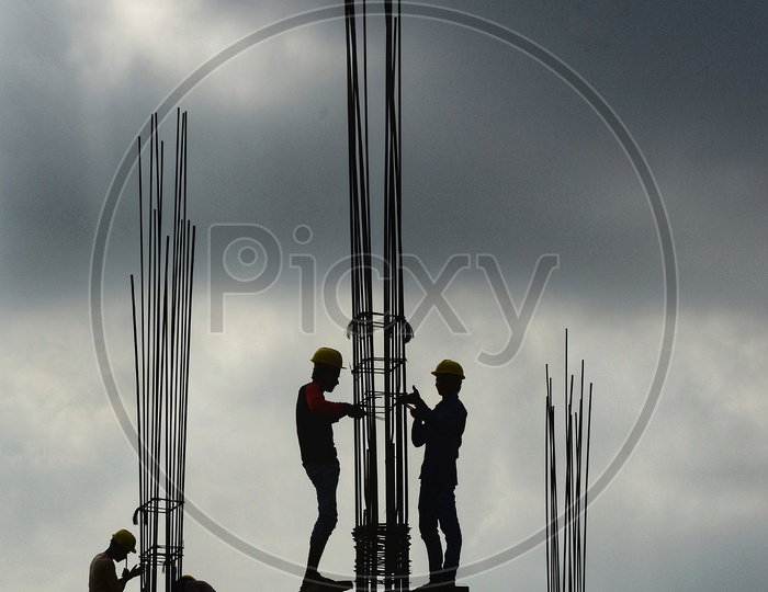 Construction Workers tying the column together