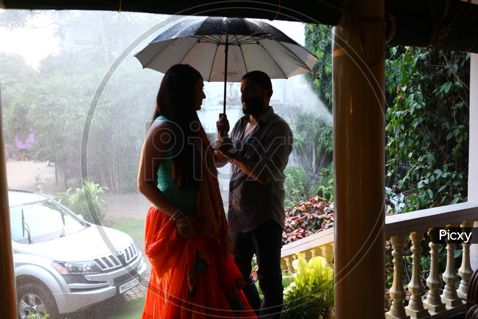 Young Couple Lovers Under an Umbrella
