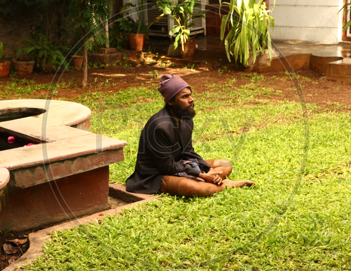 Indian Man With Beard Sitting on Lawn Grass