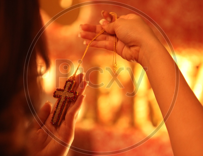 Woman Holding Holy Cross in hands