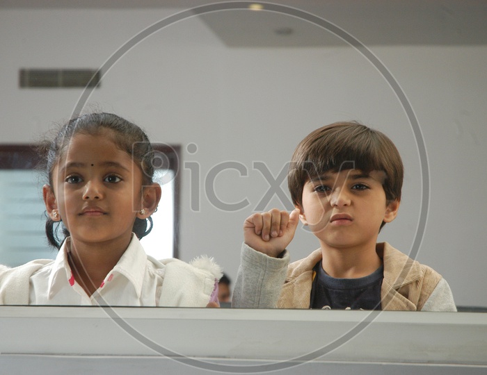 Children Looking Through Glass Window