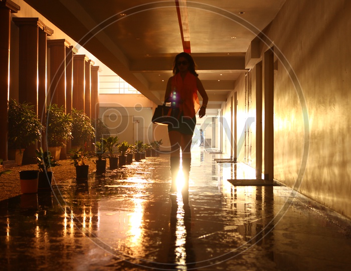Silhouette Of a Woman Walking In a Corridor