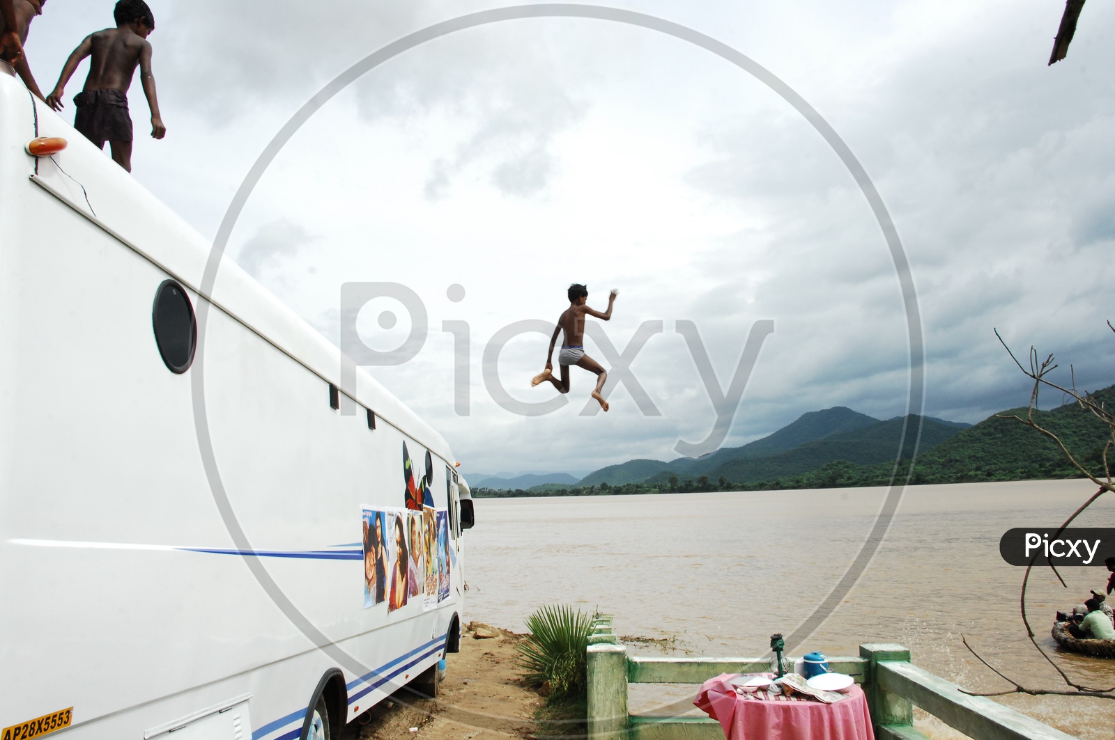Boy Jumping Into River For Swimming