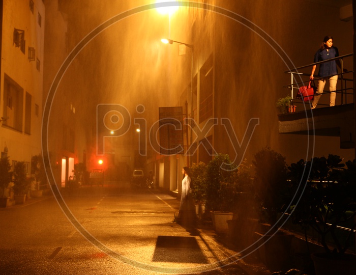 A Woman Under a Street Light In a Street