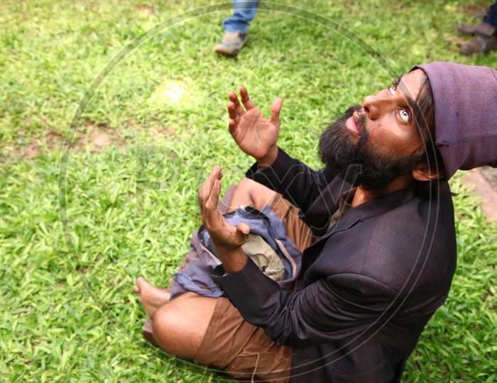 Indian Man With Beard Sitting on Lawn Grass