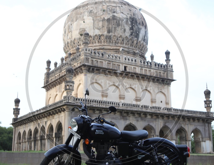 Royal Enfield Bike and Qutub Shahi Tombs in Background