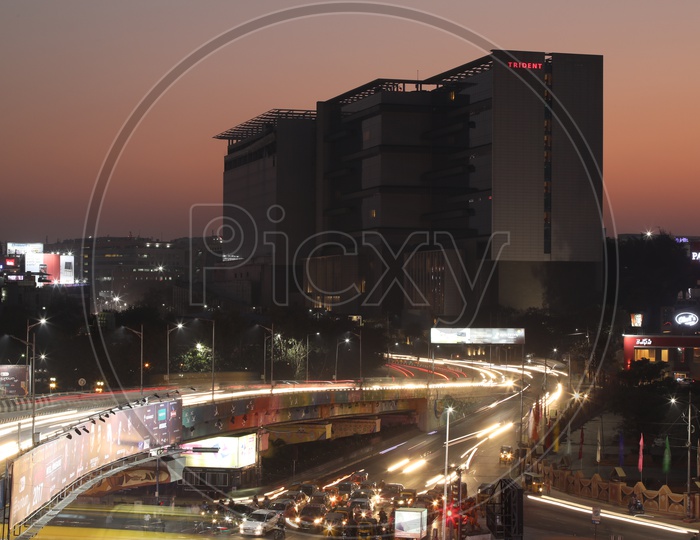 Long exposure   Shot of Fast Moving Vehicles At Hi-tech City Flyover Signal With Trident Hotel In Background