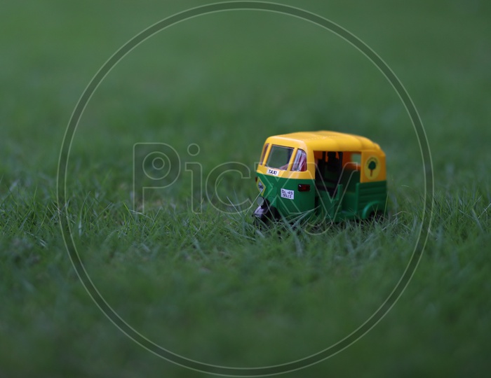 CNG Auto Green Auto  Miniature On  Green Lawn Grass Background