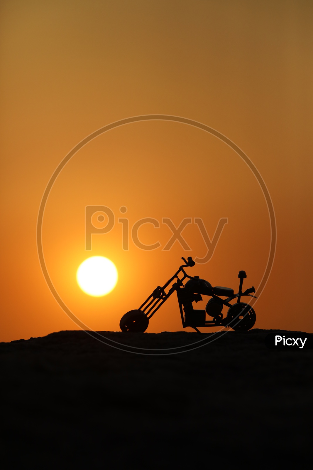 Toy Bike with Sunset in Background
