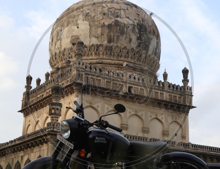Royal Enfield Bike and Qutub Shahi Tombs in Background