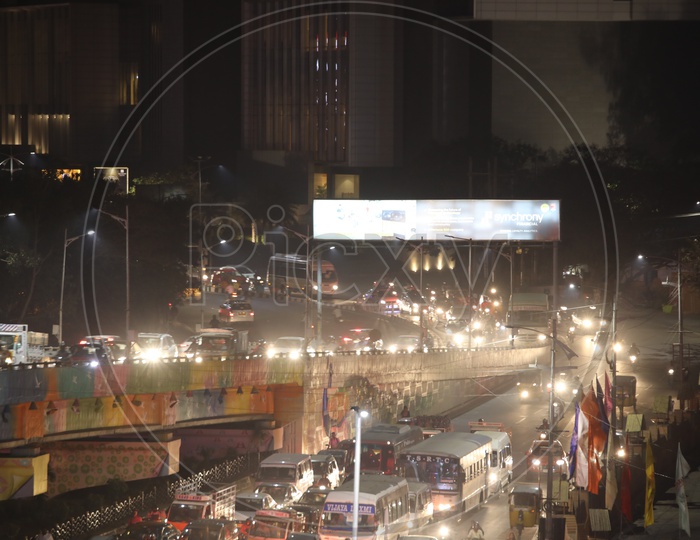 Long Exposure Shot Of  Moving Vehicles At Hi-tech Cit y Traffic  Signal And flyover