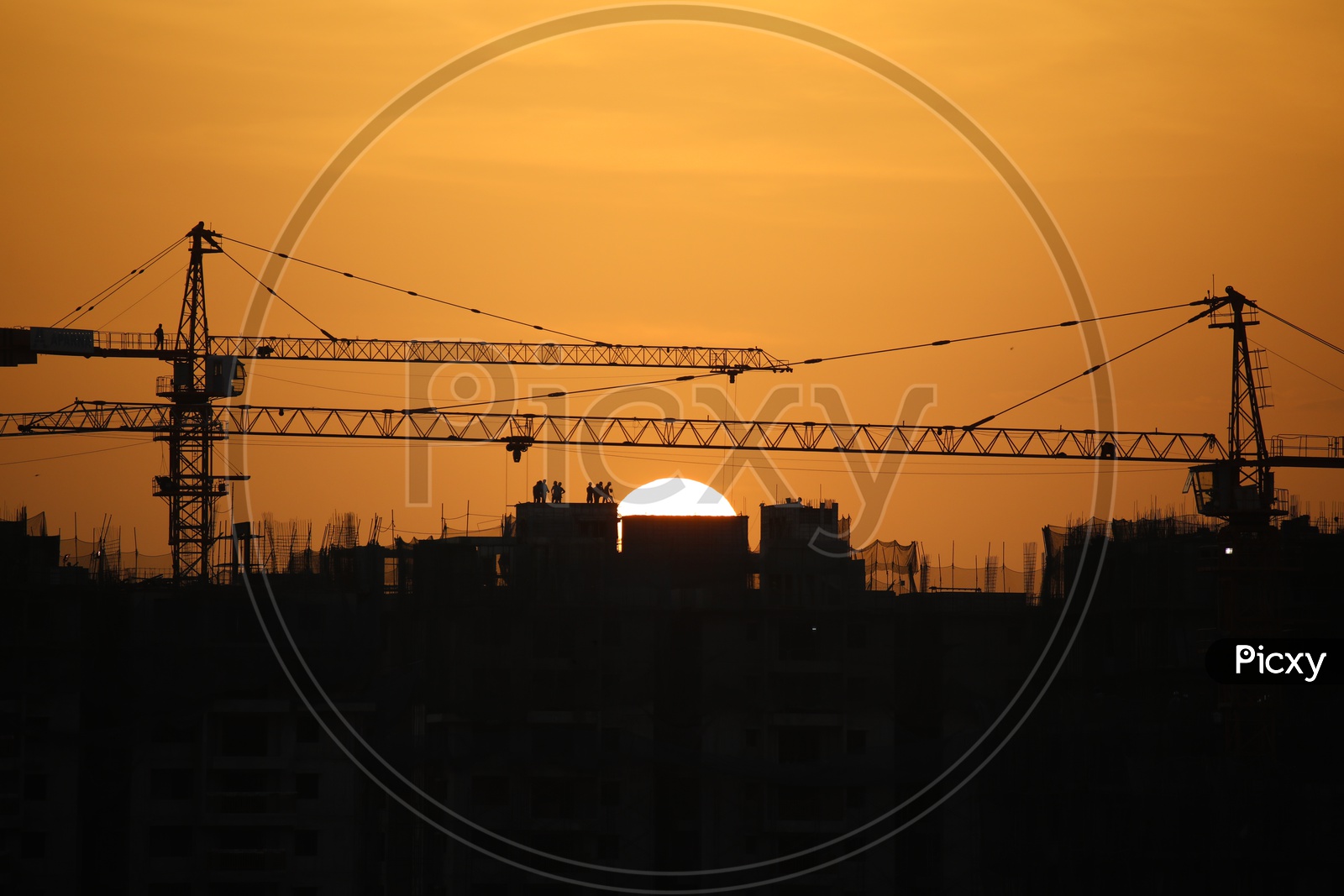High Rise Apartments Construction with Sun in Background