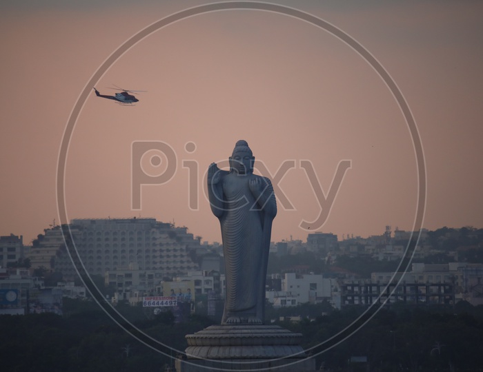 Helicopter Chopper Flying Over Buddha Statue At Tankbund