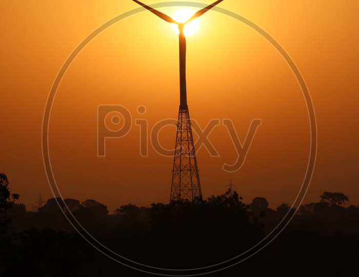 Wind Turbine with Sunset in Background