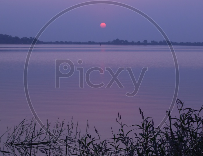 Sunset Over a Lake With Blue Hour Sky Background