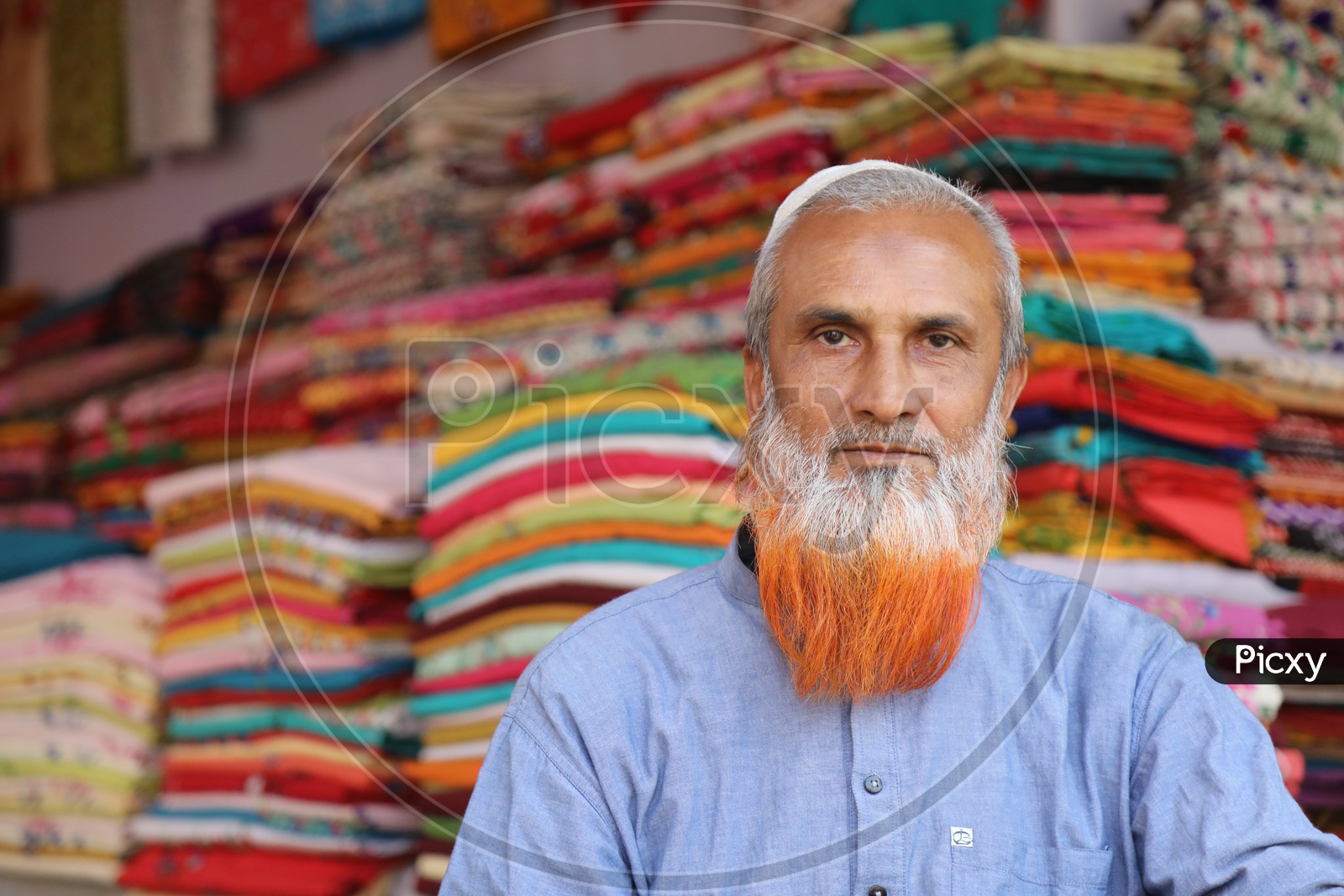 Muslim Man Clothes Vendor In a Stall