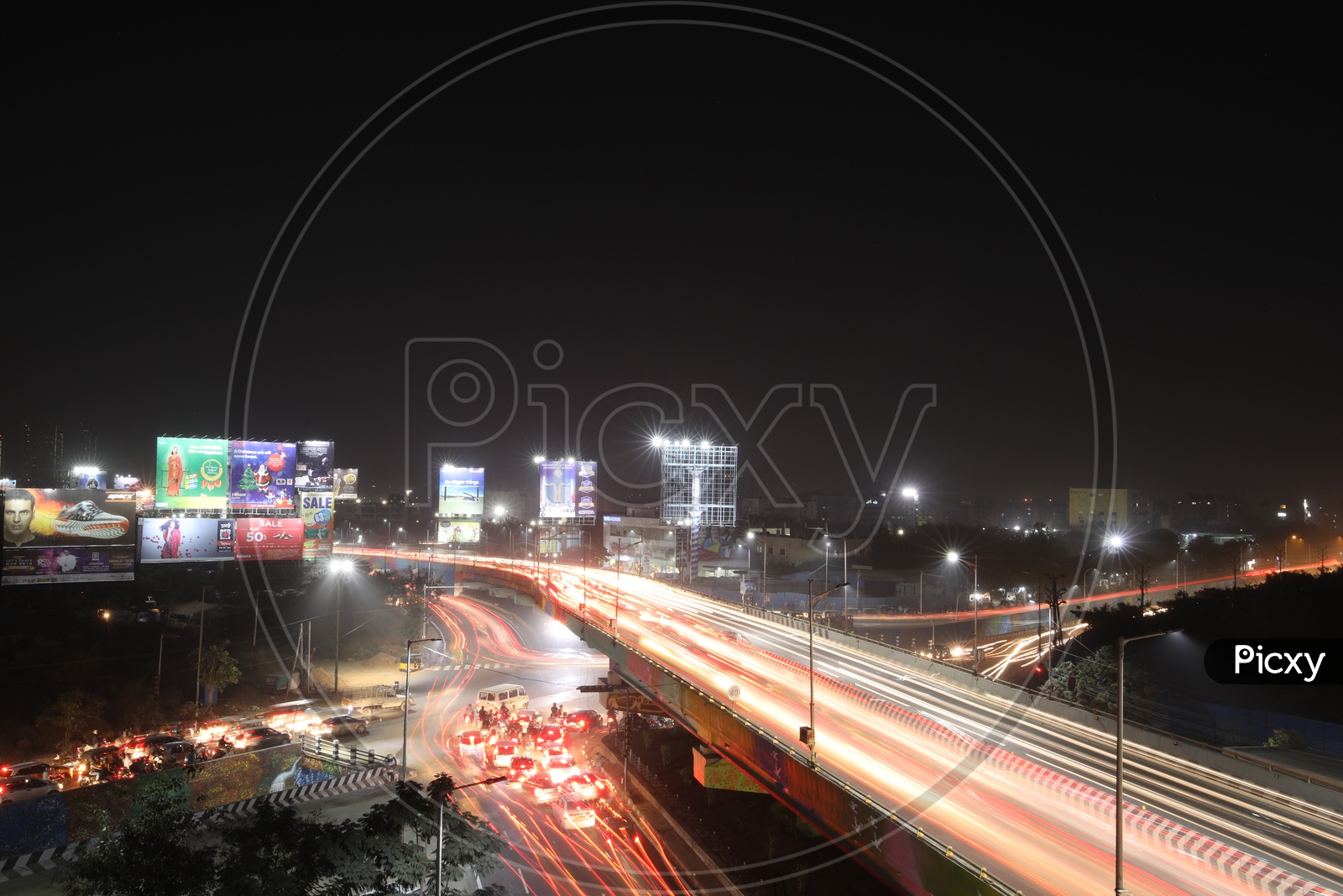 Long exposure Shot Of Fast Moving Vehicles On Flyover And At Hi-tech City Traffic Signal