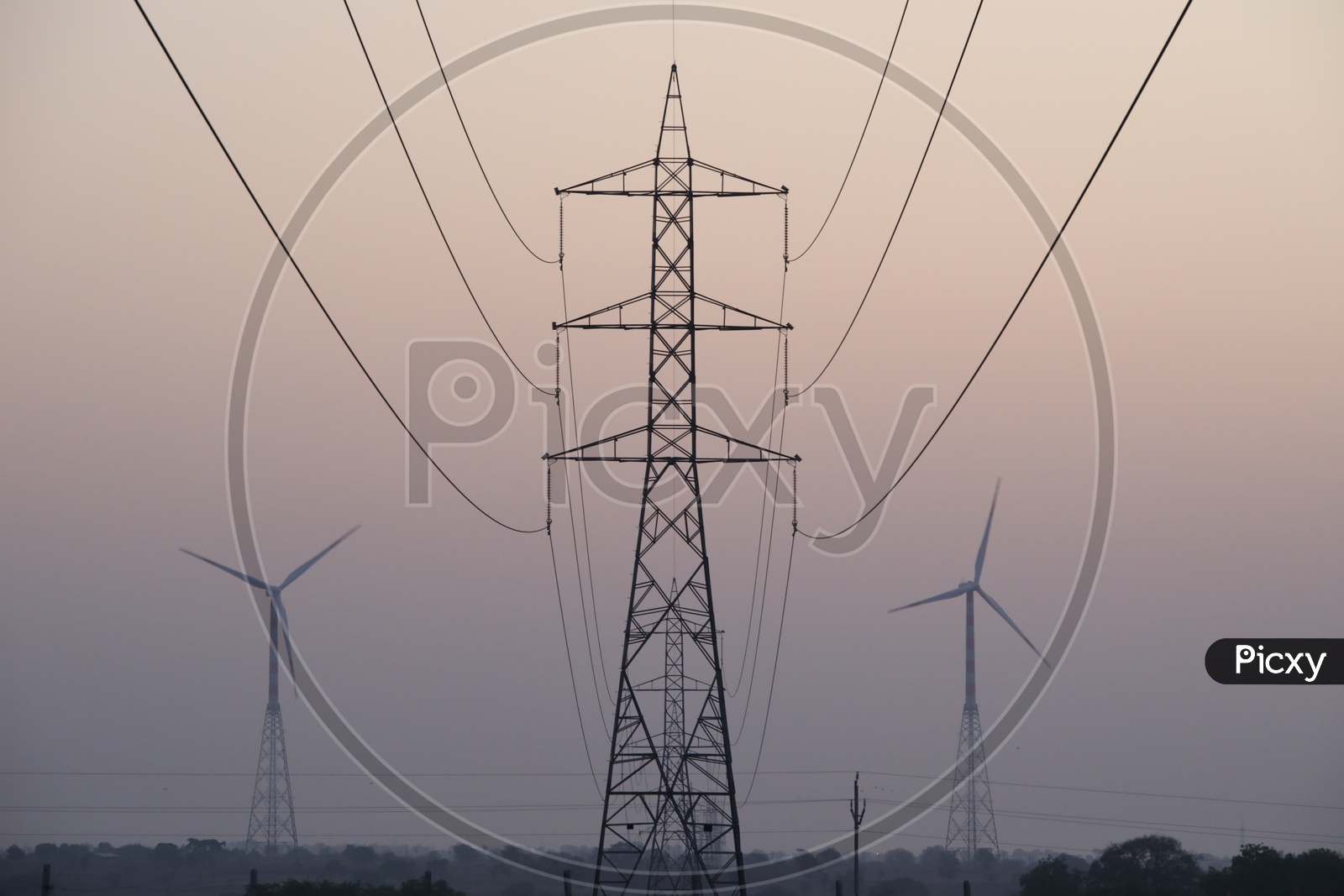 Power Transmission Towers and Wind Turbines in Background