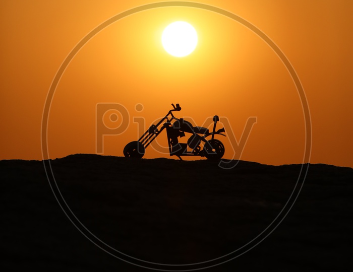 Toy Bike with Sunset in Background