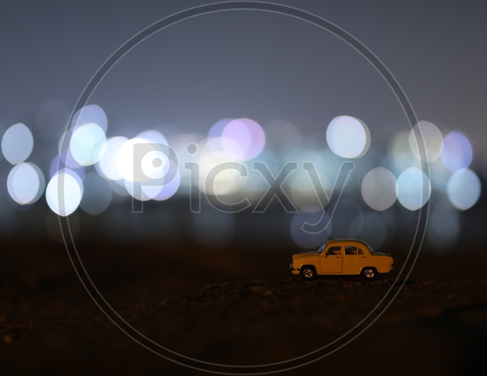 Yellow Car Taxi Miniature With City Scape Light Bokeh Background