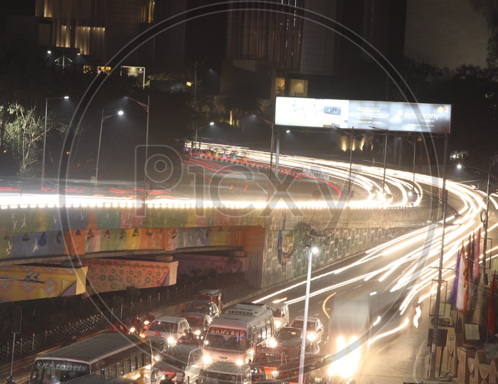Long exposure Shot Of Fast Moving Vehicles On Flyover And At Hi-tech City Traffic Signal