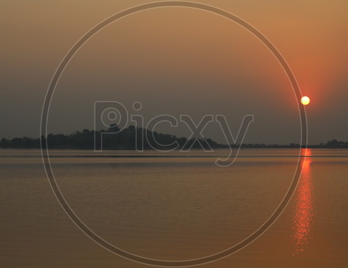 Sunset Over a Lake With Golden Sky Background