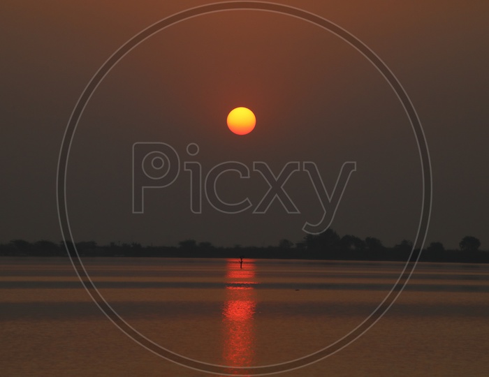 Sunset Over a Lake With Golden Sky Background