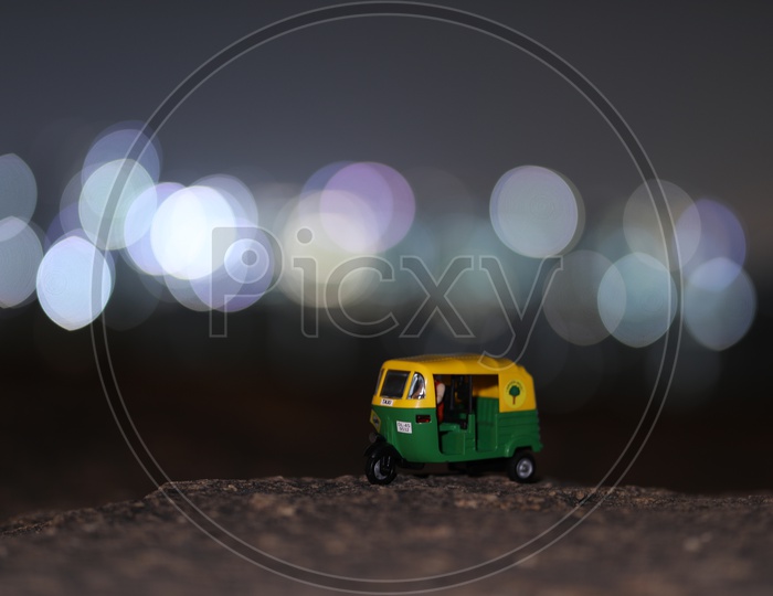 CNG  Auto Green Auto Miniature With City Scape Light Bokeh Background