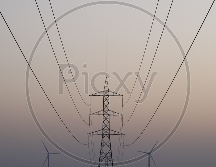Power Transmission Towers and Wind Turbines in Background
