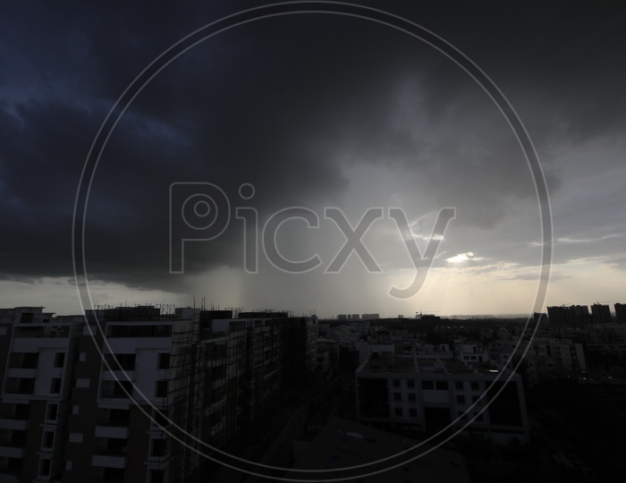 Dark Clouds Over A City Scape  With High Rise Apartments