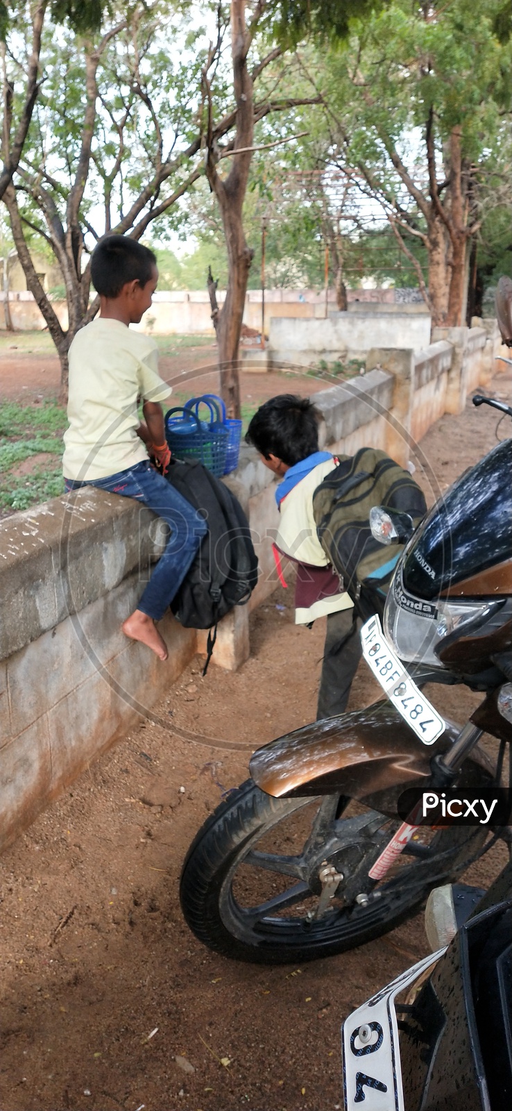 A child struggling to lift his over weighed school bag