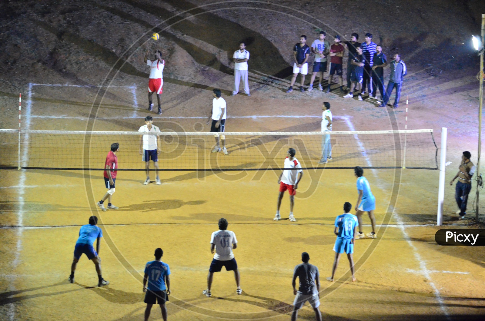 Image of Young Players Students Playing Volleyball in a College Campus